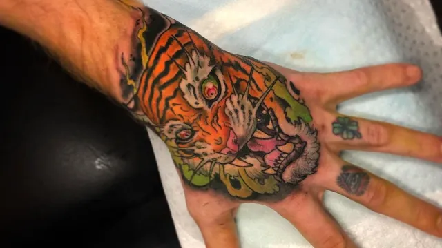 Hand with tiger tattoo