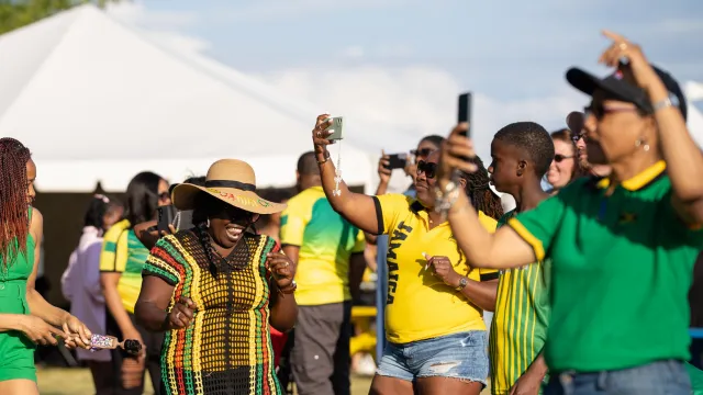 woman dancing in Jamaican flag colour